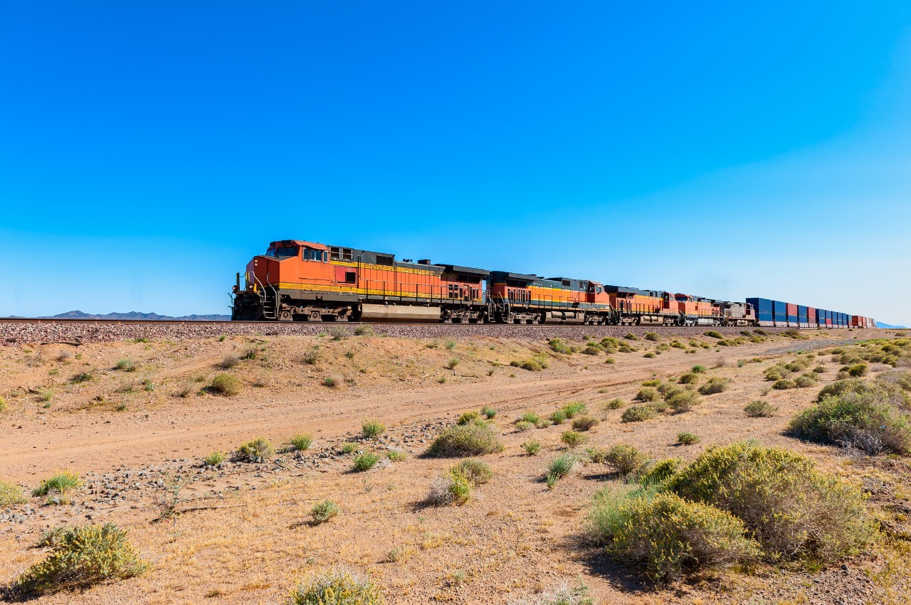 Freight Train driving through Mojave Desert along Route 66, California, USA.
