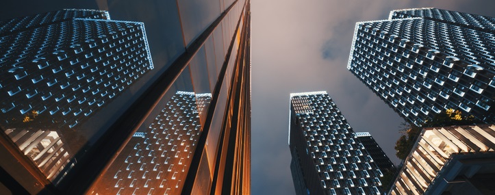 Modern skyscrapers illuminated at night reflecting on a glass facade low angle view in Chengdu, Sichuan province, China